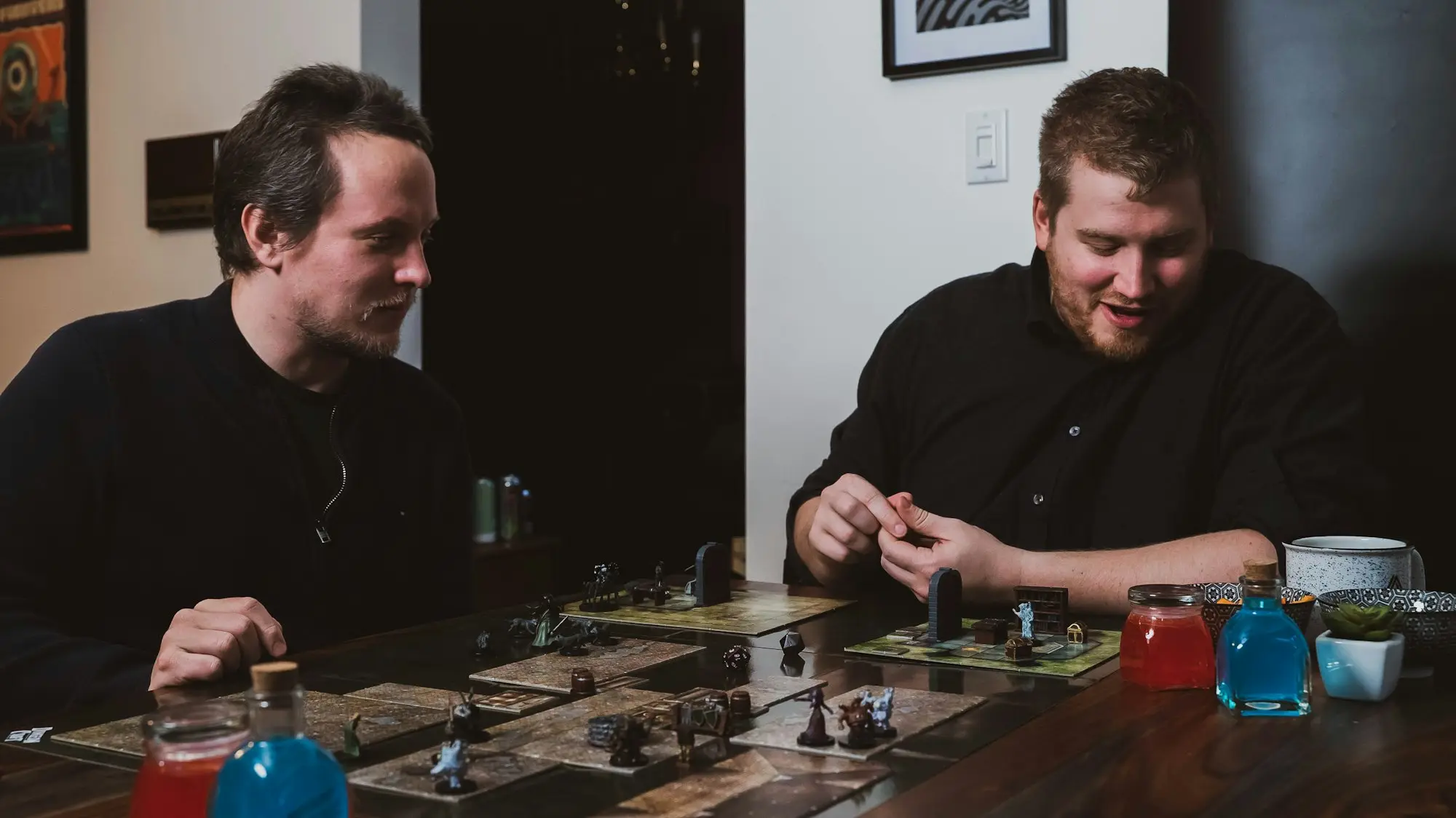 Two friends playing a tabletop roleplaying game together at a table