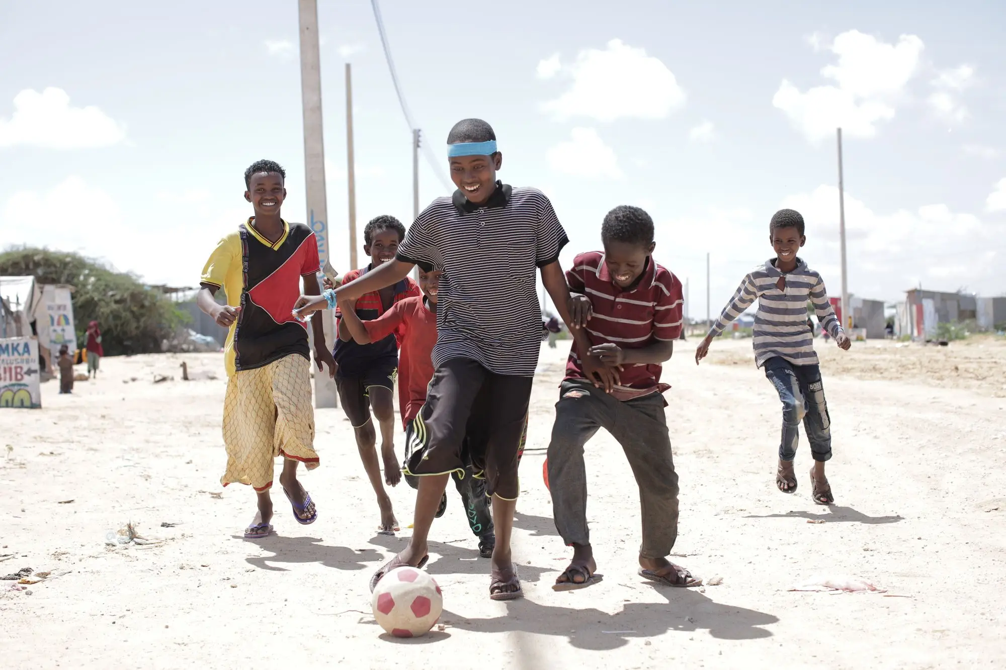 Kids playing a street football game together
