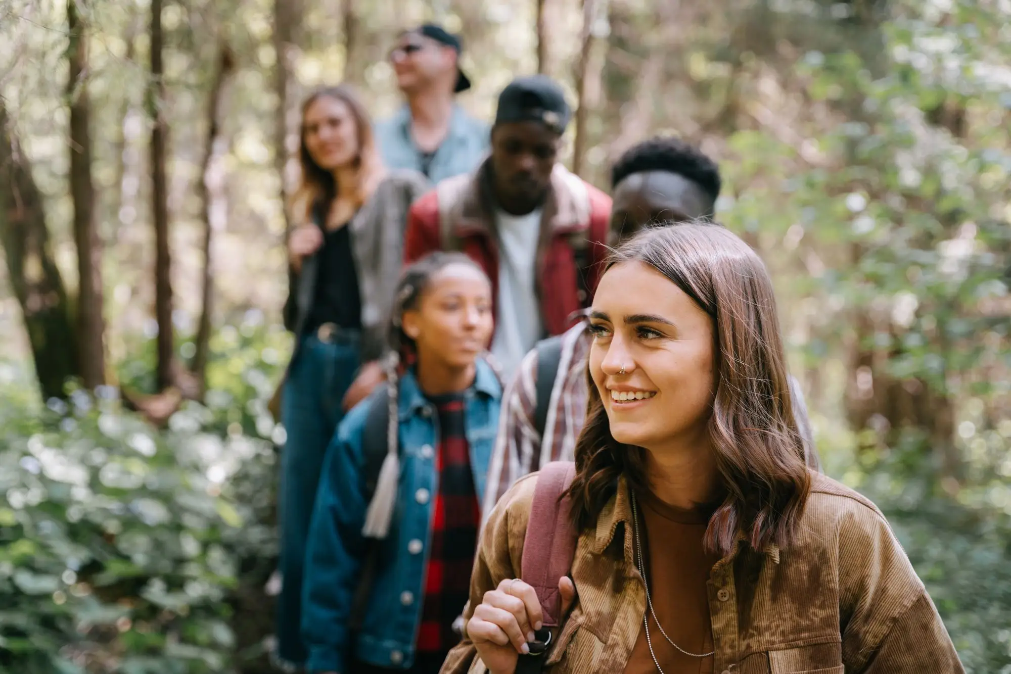A group of friends hiking together through forest