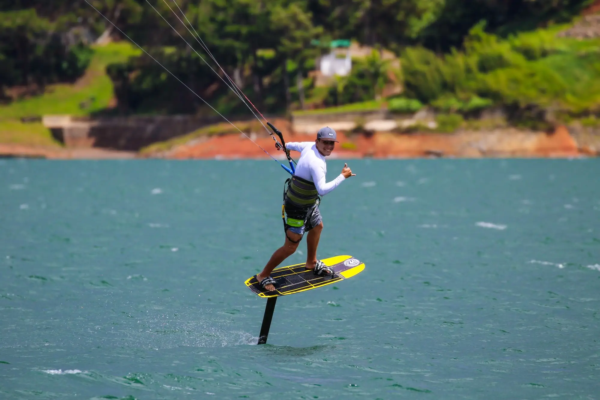 A kitesurfer riding with the kite lines overhead