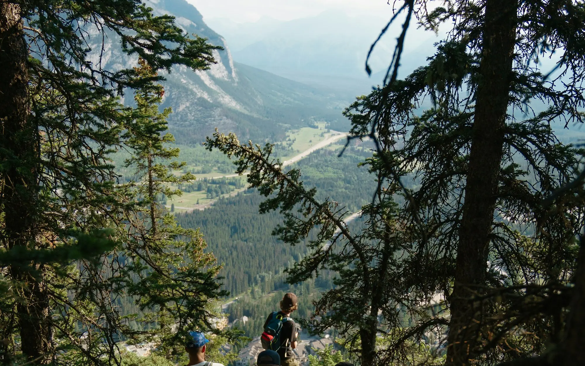 Hikers pausing together at a mountain viewpoint