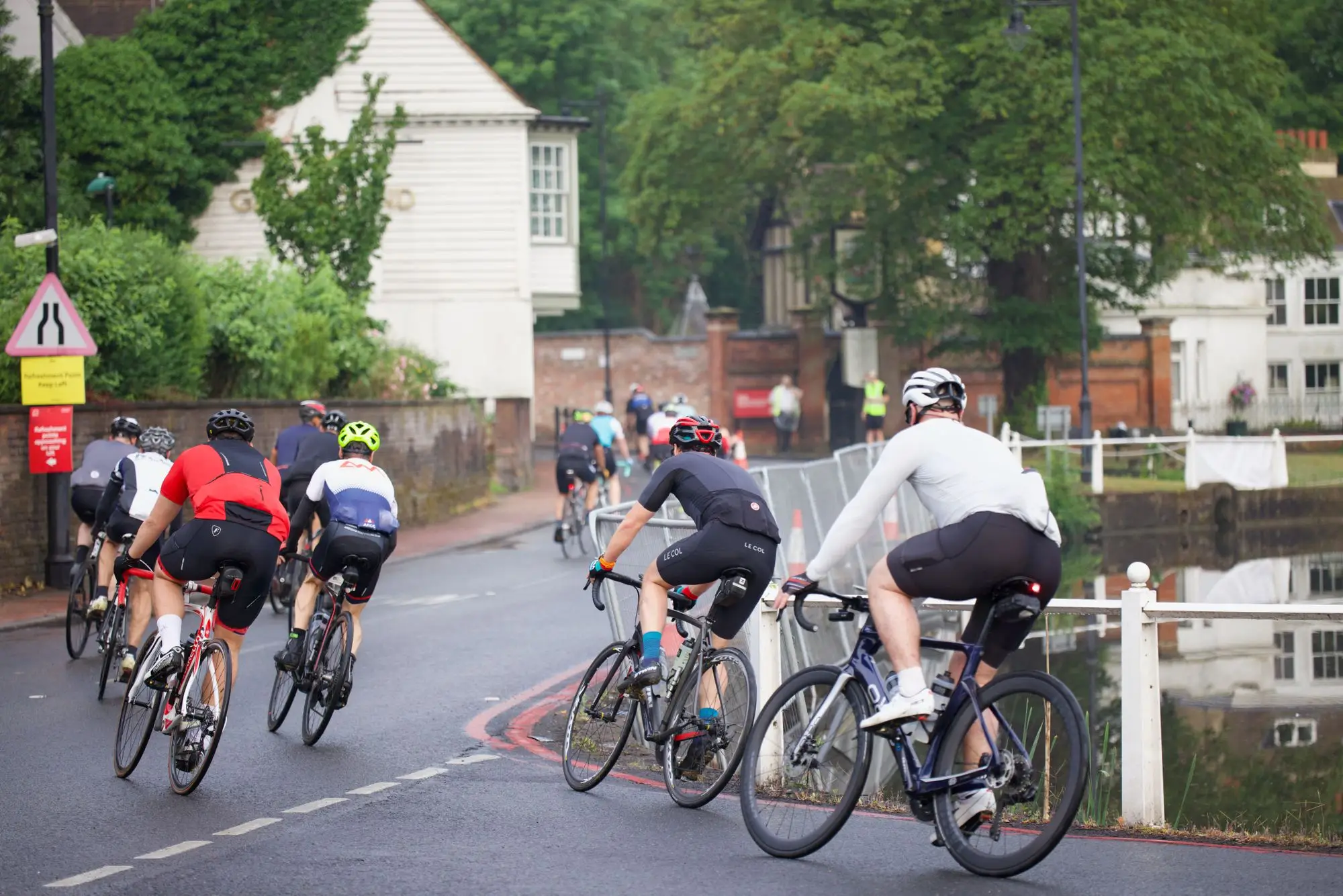 A group of cyclists riding together on the road