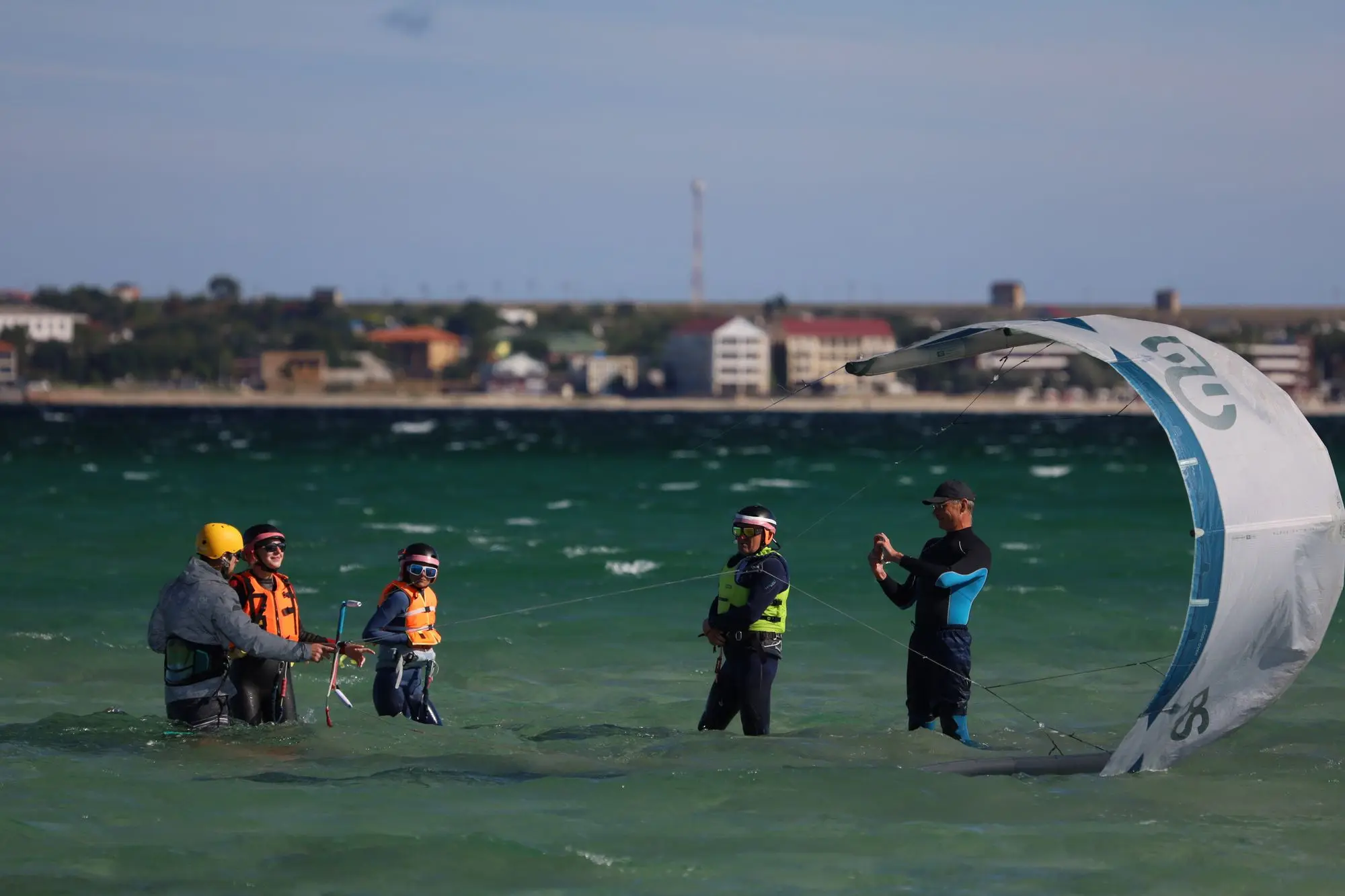 A group out on the water together during a kitesurfing session